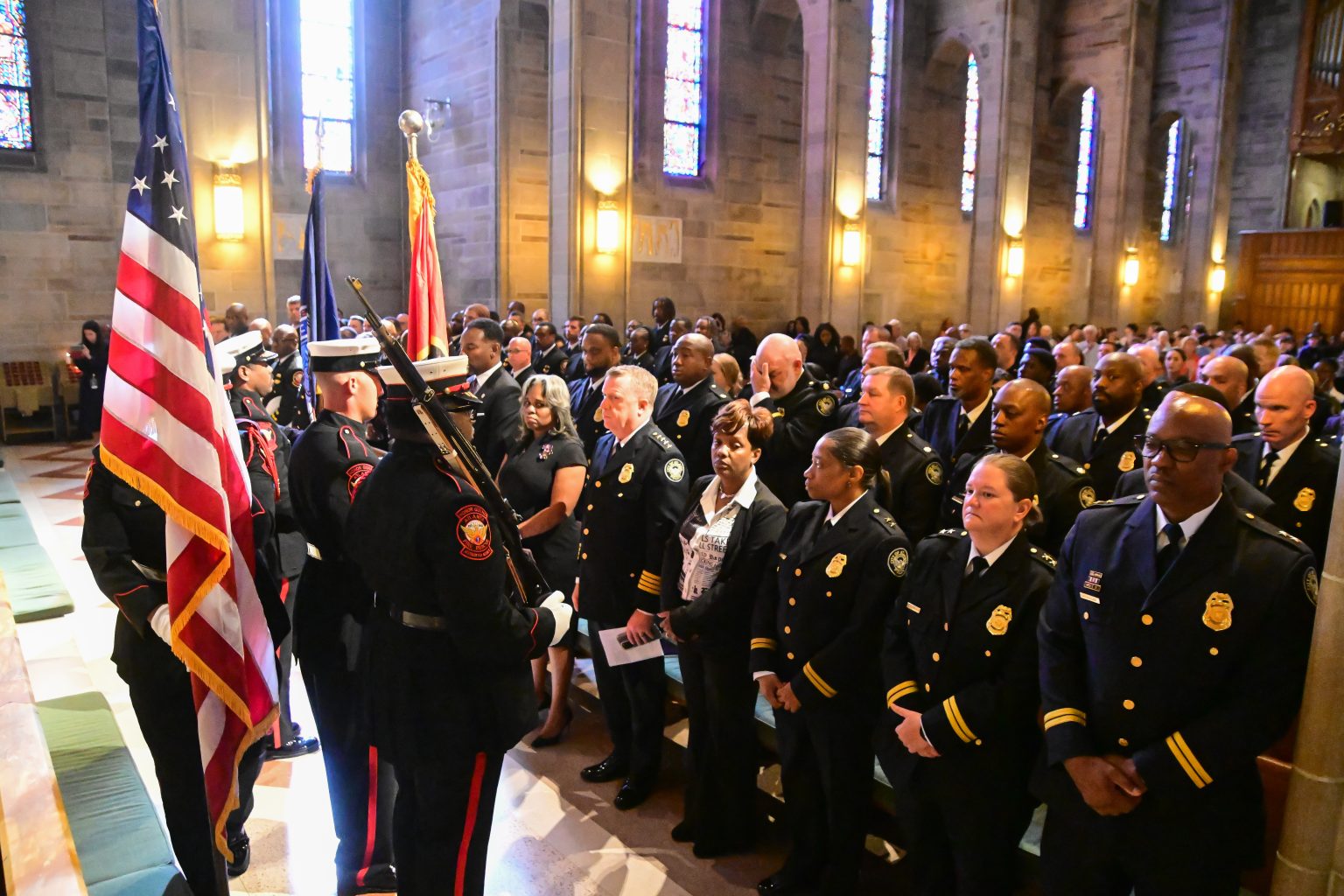 Community members and city officials stand together to honor public safety personnel at the 2025 Blue Mass