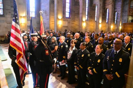 Community members and city officials stand together to honor public safety personnel at the 2025 Blue Mass